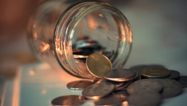 clear glass jar with coins