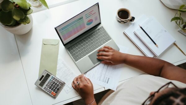 a person sitting at a table with a laptop